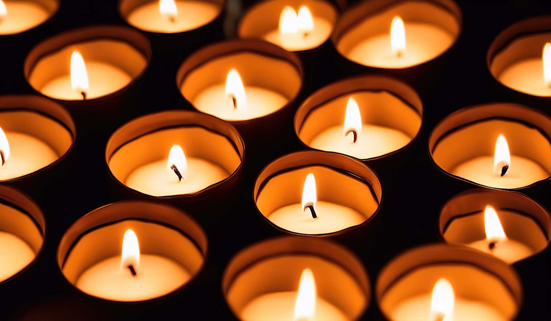 Tea light candles burning in the dark
